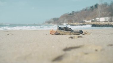Missing drowned Refugee body rescue mission. Thousands of refugees drown on their way to Europe. Discarded personal belongings of refugees washed up on shoreline
