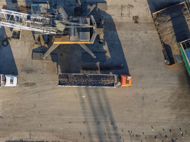 Aerial View of Cargo Truck Loading Sunflower Seeds in Port Facility with Industrial Equipment.  clipart