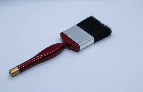 stock image Black and red paint brushes on white background