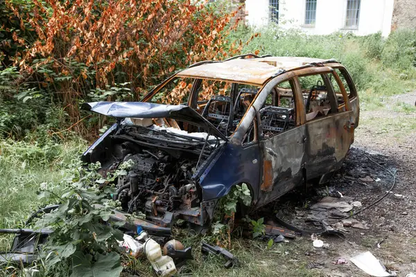 stock image Car after a fire. Burnt rusty car after fire or accident. Car after the fire, crime of vandalism, riots. Arson car. Accident on the road due to speeding. Explosion