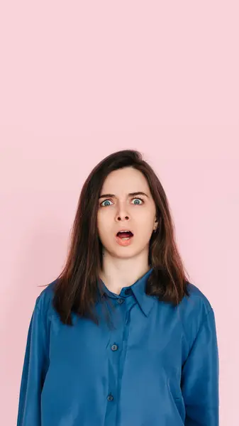 stock image Stunning Portrait of a Speechless Woman in Utter Shock, Wide Open Mouth, Expressing Unbelievable Surprise - Isolated on Vibrant Pink Background.