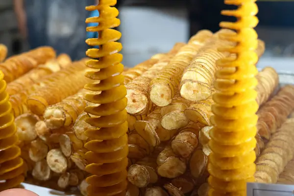 stock image Tornado potato also called twist potato or potato twister on a stick at a street food stall