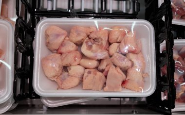 Raw chicken butt tail end parts packed in a container at a supermarket. A.k.a. pope's nose and uropygium.