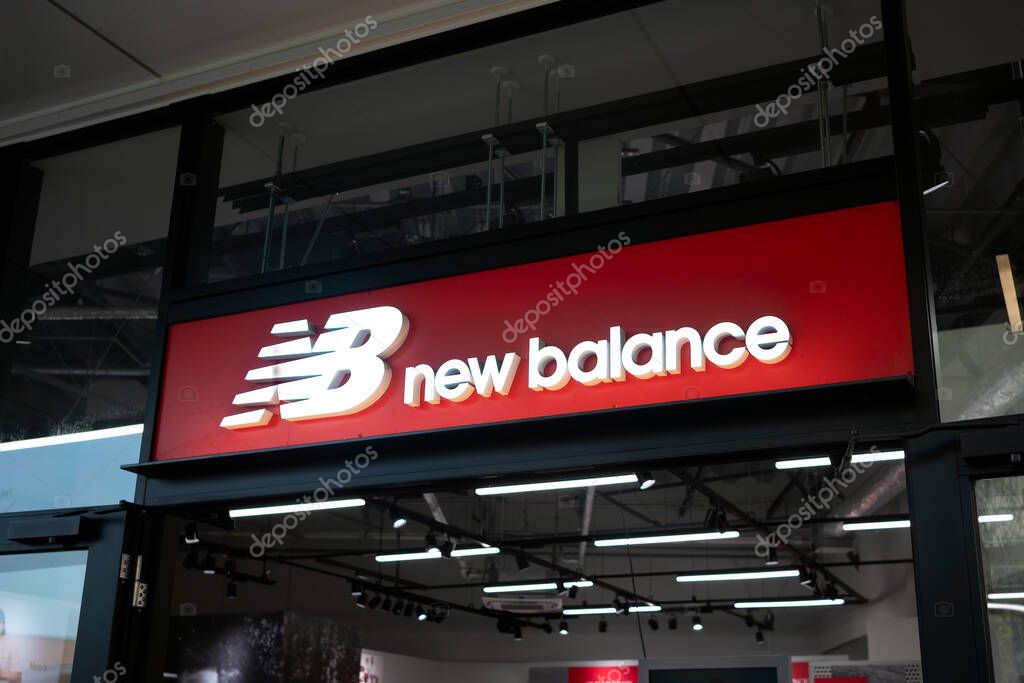 New Balance outlet store storefront and logo