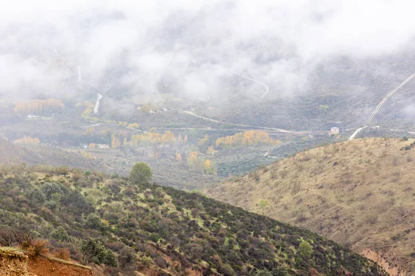 stock image valley eroded, over the centuries, between the provinces of guadalara and madrid in spain, called las carcavas, covered by fog