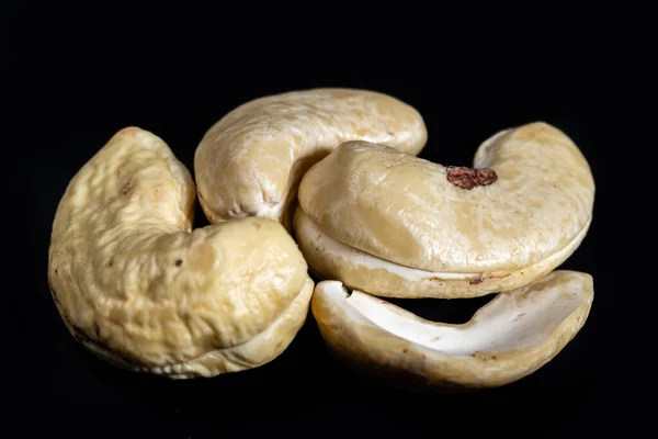 raw cashew nuts on black background