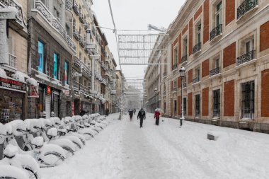 snow-covered electric bikes Snowscape in a street in Madrid due to the snowstorm Filomena