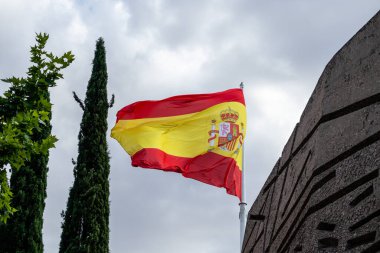 Flag of spain in a deep blue sky with wind
