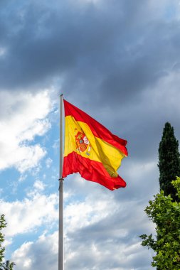Flag of spain in a deep blue sky with wind