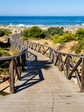 wooden walkways to access the beach of La Barrosa, Cadiz, Spain