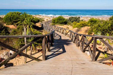 wooden walkways to access the beach of La Barrosa, Cadiz, Spain