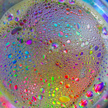 Colorful artistic of oil drop floating on the water and oil