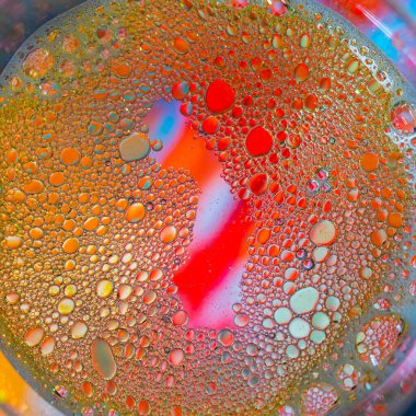 Colorful artistic of oil drop floating on the water and oil