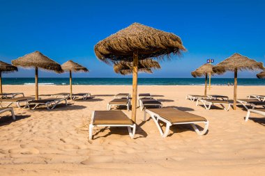Parasols and hammocks on La Barrosa beach in Sancti Petri, Cadiz, Spain
