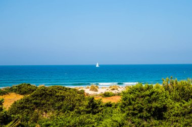 pleasure boats passing in front of La Barrosa beach in Sancti Petri Cadiz