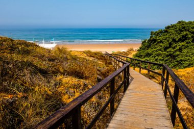 wooden walkways, access to La Barrosa beach in Sancti Petri, Cadiz, Spain