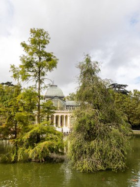Palacio de Cristal del Retiro in Madrid, Spain. Inside property with view of the blue cel by behind glass