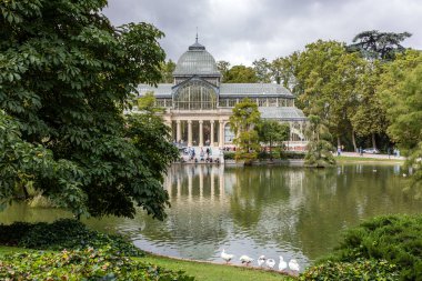 Palacio de Cristal del Retiro in Madrid, Spain. Inside property with view of the blue cel by behind glass