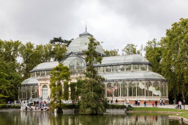 Palacio de Cristal del Retiro in Madrid, Spain. Inside property with view of the blue cel by behind glass