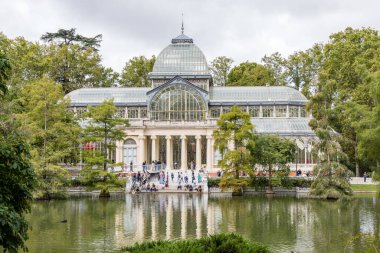 Palacio de Cristal del Retiro in Madrid, Spain. Inside property with view of the blue cel by behind glass