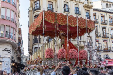 Hooded nazarenos in procession in Granada Andalucia, Spain during Semana Santa, Holy Week