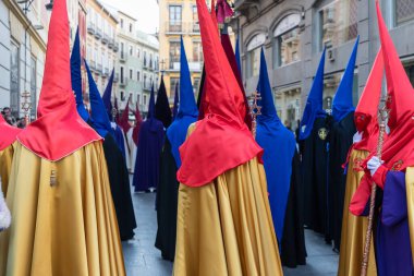 Hooded nazarenos in procession in Granada Andalucia, Spain during Semana Santa, Holy Week
