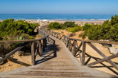 Wooden walkway that gives access to La Barrosa beach in Sancti Petri, Cadiz