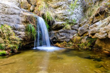 Small water lagoon called Kinderland Pond in the mountains of Madrid, right in La Pedriza