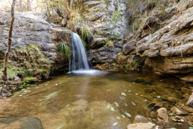 Small water lagoon called Kinderland Pond in the mountains of Madrid, right in La Pedriza