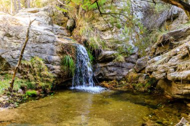 Small water lagoon called Kinderland Pond in the mountains of Madrid, right in La Pedriza