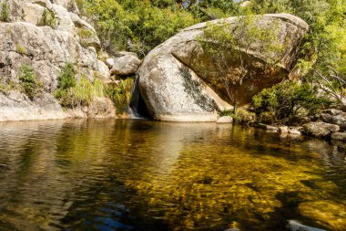 Small water lagoon called Kinderland Pond in the mountains of Madrid, right in La Pedriza