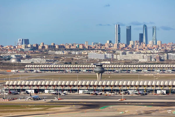 stock image Madrid, Spain - March 14, 2023: airplanes landing at Adolfo Suarez Madrid Barajas Airport MAD with the city skyline in the background in Madrid, Spain