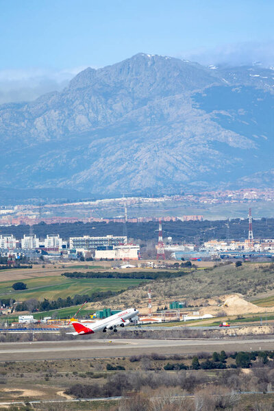 Madrid, Spain - March 14, 2023: airplanes taking off at Adolfo Suarez Madrid Barajas Airport MAD with the city skyline in the background in Madrid, Spain