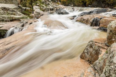 Water torrent of the Manzanares river in the Pedriza area of Madrid clipart