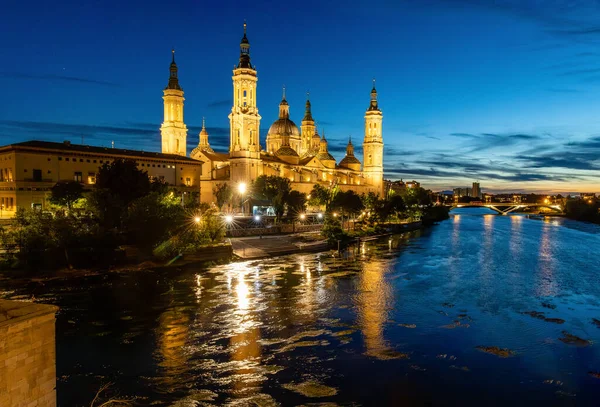 stock image Zaragoza, Spain - May 01, 2023: ebro river, in front of the Basilica del Pilar, with very low water level due to drought and climate change in Zaragoza, Spain