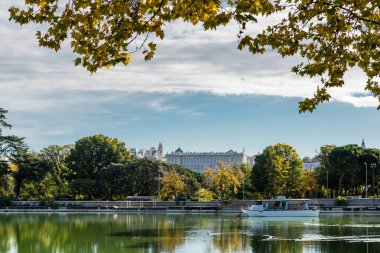 Lake of the Casa de Campo park with autumn colored trees in Madrid