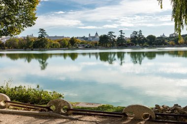 Lake of the Casa de Campo park with autumn colored trees in Madrid