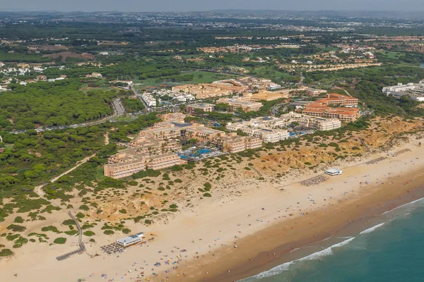 aerial view, of the hotel complexes, from a paraglider, of the Barrosa beach in Sacti Petri, Cadiz, Spain