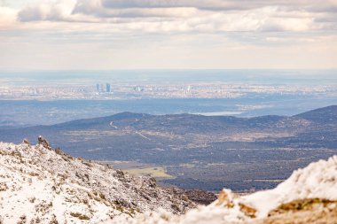 views of the city of Madrid from the snow-covered port of Navacerrada clipart