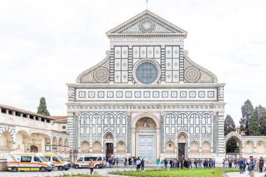 Florence, Italy - April 10, 2024: Basilica of Santa Maria de Novella in Florence with the surrounding area full of tourists in Florence, Italy clipart