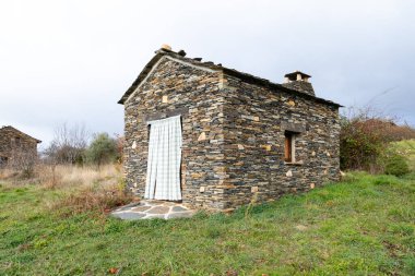 Slate stone antique village of Roblelacasa. Black architecture. Guadalajara, Spain clipart