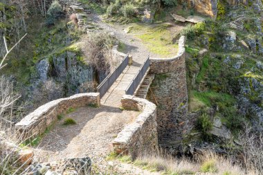 Medieval bridge called Matallana in the area of the black villages of Guadalajara, Spain clipart