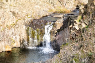 Aljibe waterfall in the area of the black villages of Guadalajara, Spain clipart