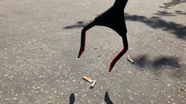 Freiwillige Die Zigarettenstummel Aus Beton Mit Einer Streuzange Aufheben Detailaufnahmen — Stockvideo