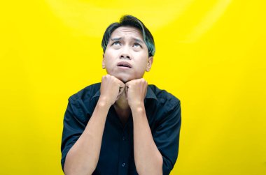 Sarı arka planda genç Asyalı bir adam 