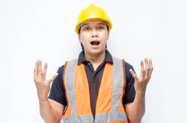 Siyah gömlekli ve sarı kasklı Asyalı mutlu inşaat işçisi reklamları gösteriyor.