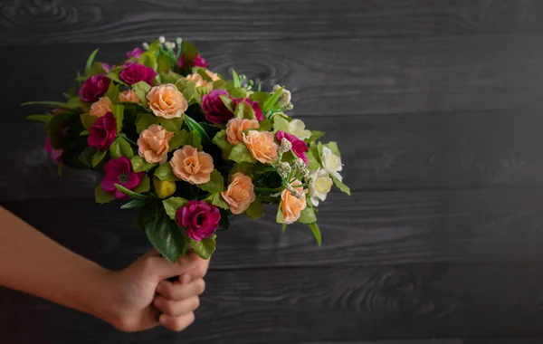 little boy holding a bouquet of flowers. Mothers Day. International Women's Day.