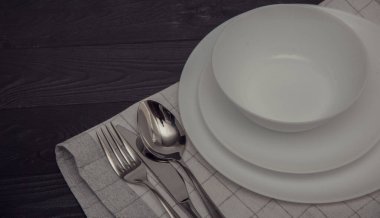 Empty white plate and cutlery, table setting