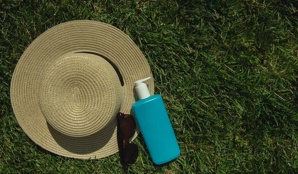 Summer vacation and skin care concept. summer hat, brown sunglasses and body lotion , vacation concept.flat lay