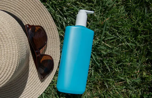 Summer vacation and skin care concept. summer hat, brown sunglasses and body lotion , vacation concept.flat lay